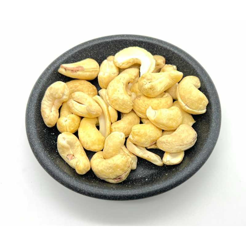 Whole cashew nuts in a dark bowl