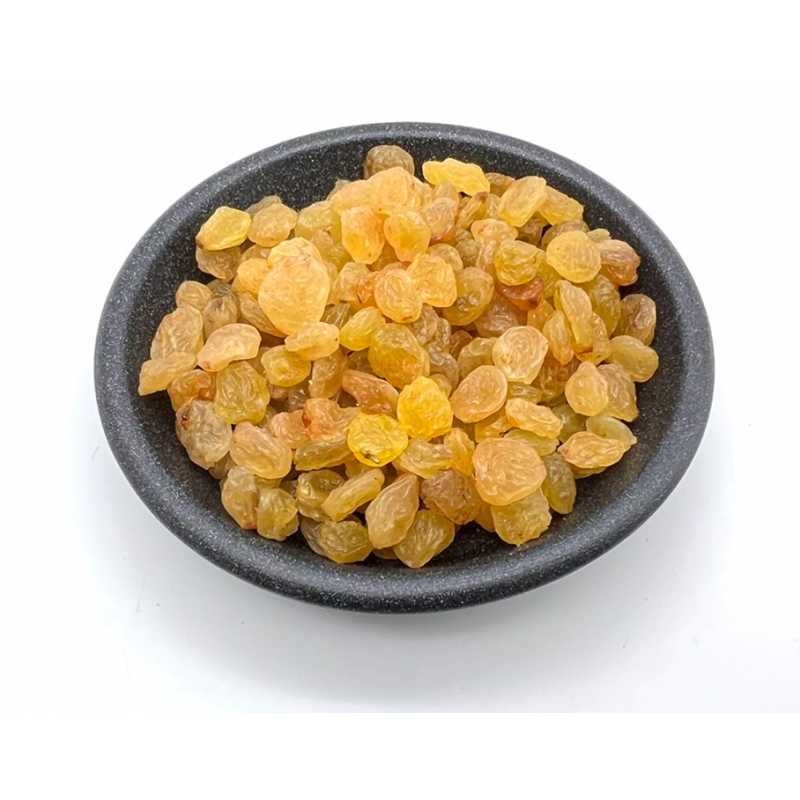 Golden raisins in a dark bowl
