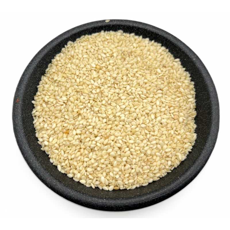 Hulled white sesame seeds in a dark bowl