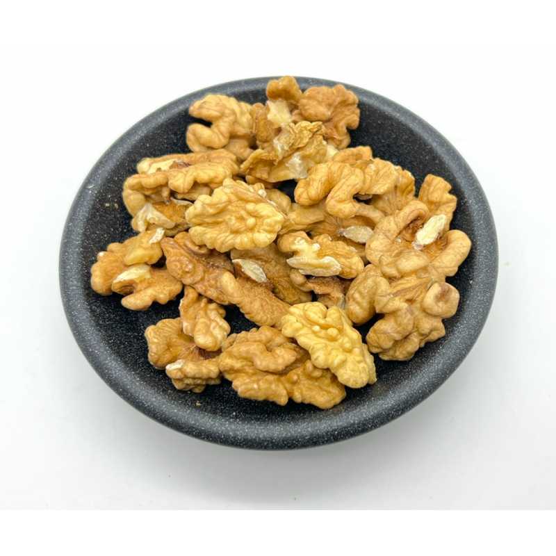 Walnut halves in a dark bowl